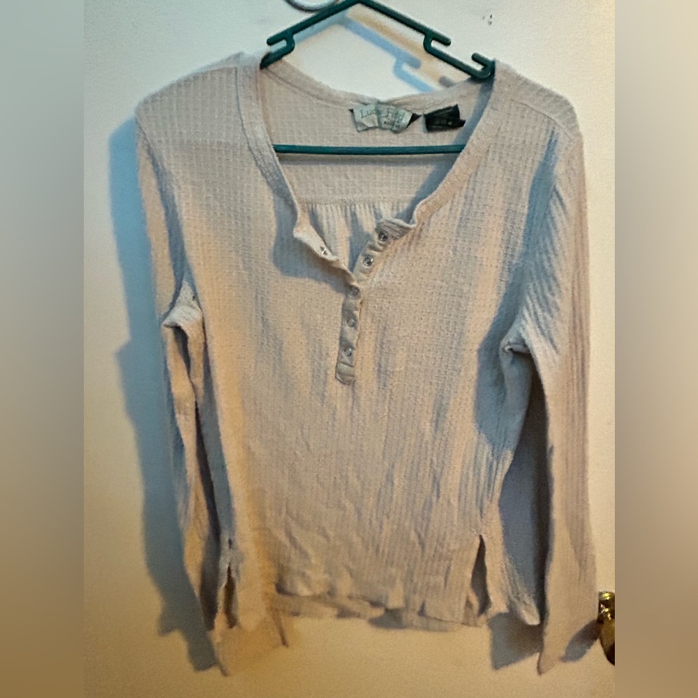Long sleeve polyester shirt with a v neck that buttons up with clasps.